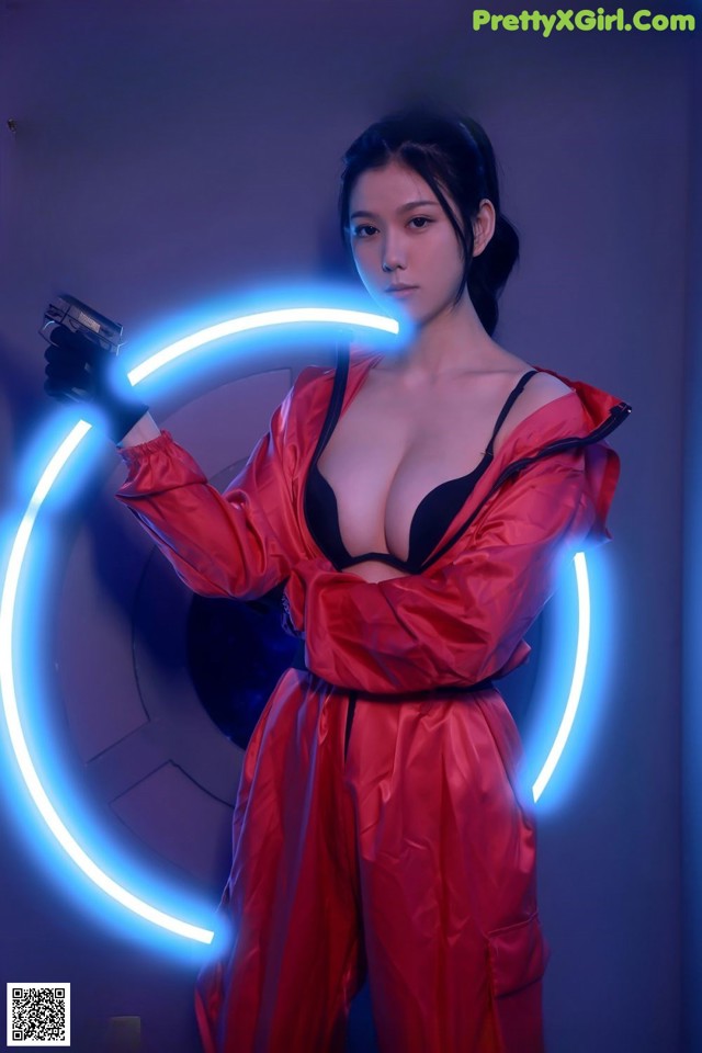 A woman in a red outfit holding a gun.