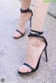 a close up of a person wearing a pair of black sandals