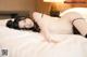 A woman laying on top of a bed in lingerie.