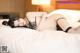 A woman laying on top of a bed in lingerie.