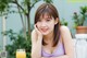 A woman sitting at a table with a glass of orange juice.