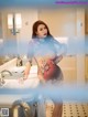 A woman standing in front of a bathroom sink.